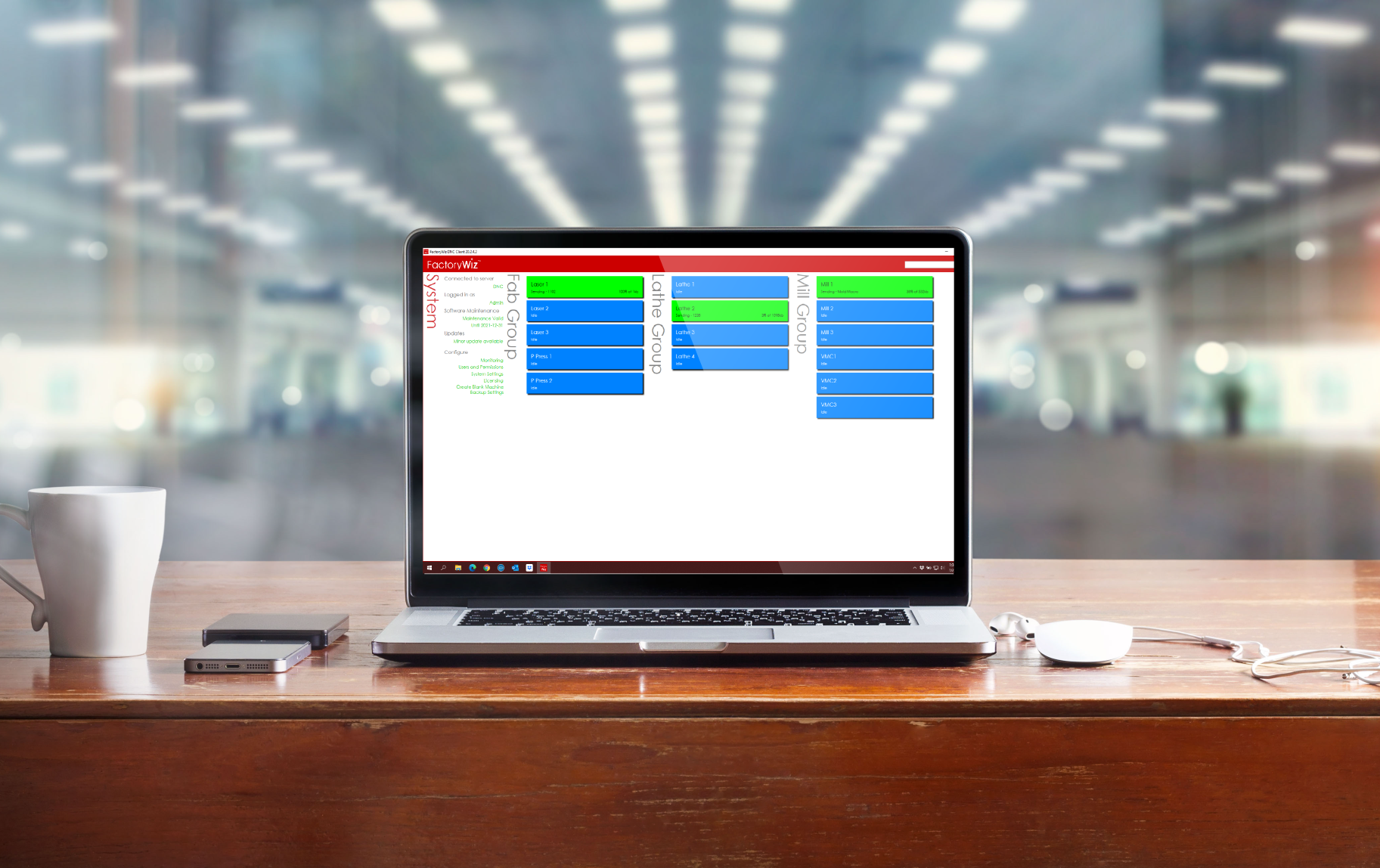 Laptop on a wood table displaying a FactoryWiz report